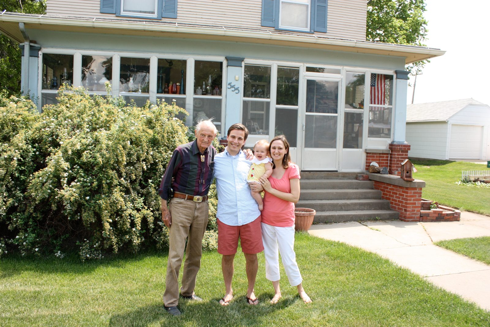 Duane standing with family in front of the Nebraska farmhouse he lived in for fifty years